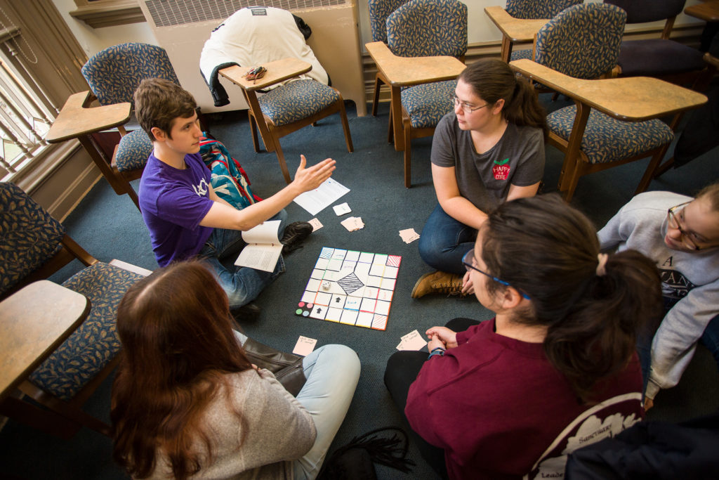 Students playing a board game that was a final project in one of my classes.