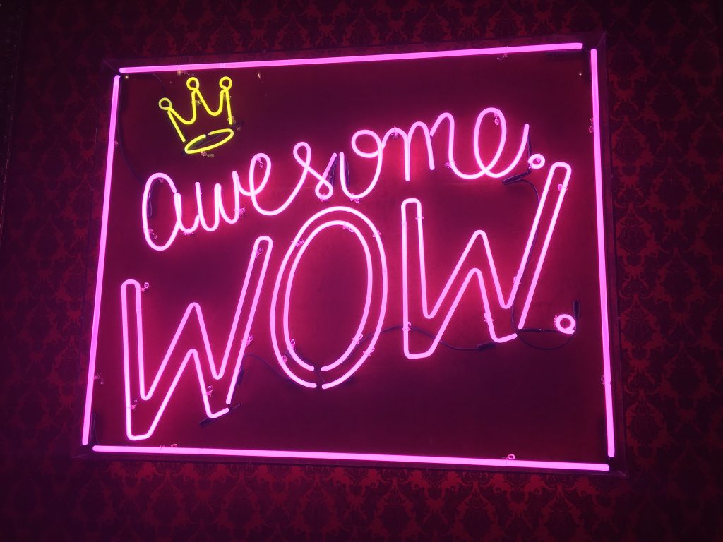 A neon sign that says 'awesome, wow!'