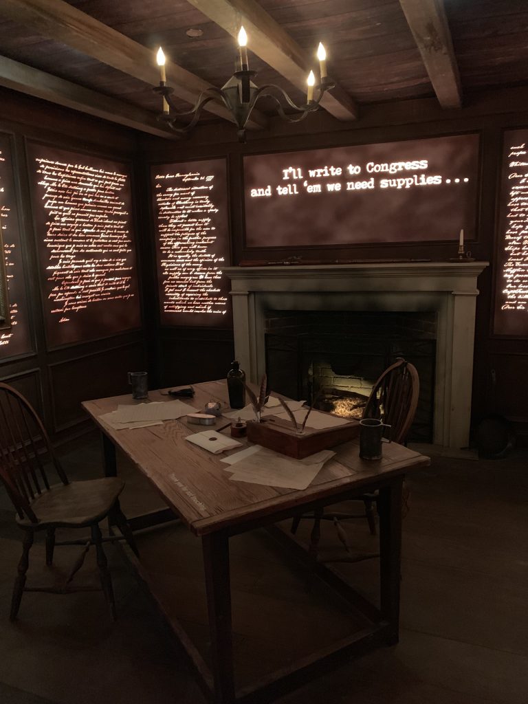 a desk in a room with writing on the walls