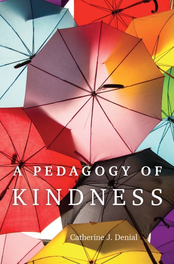 The cover of a book called "A Pedagogy of Kindness." The cover image is taken from beneath a canopy of brightly-colored, open umbrellas, set against a bright, sunny sky.